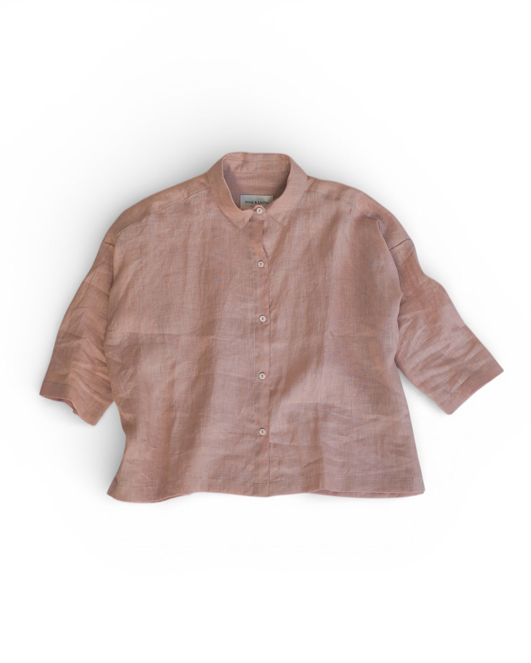 The Boxy Cropped Linen Blouse No.22 in Sepia Rose by Pyne and Smith Clothiers features a loose fit, mandarin collar, button-down front, and three-quarter sleeves. Made from GOTS certified linen and shown laid flat on a white background.