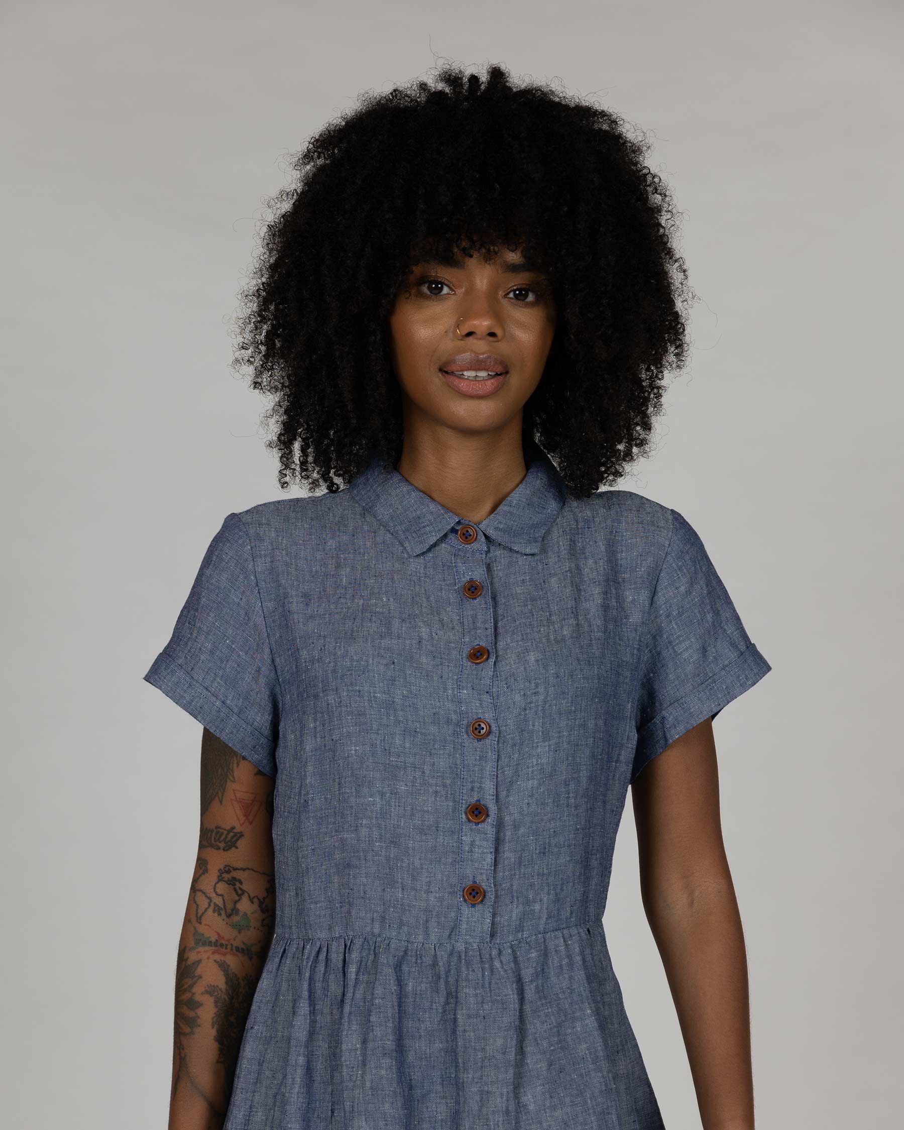 Upper front view of model wearing dress model number 23 in Oxford chambray linen