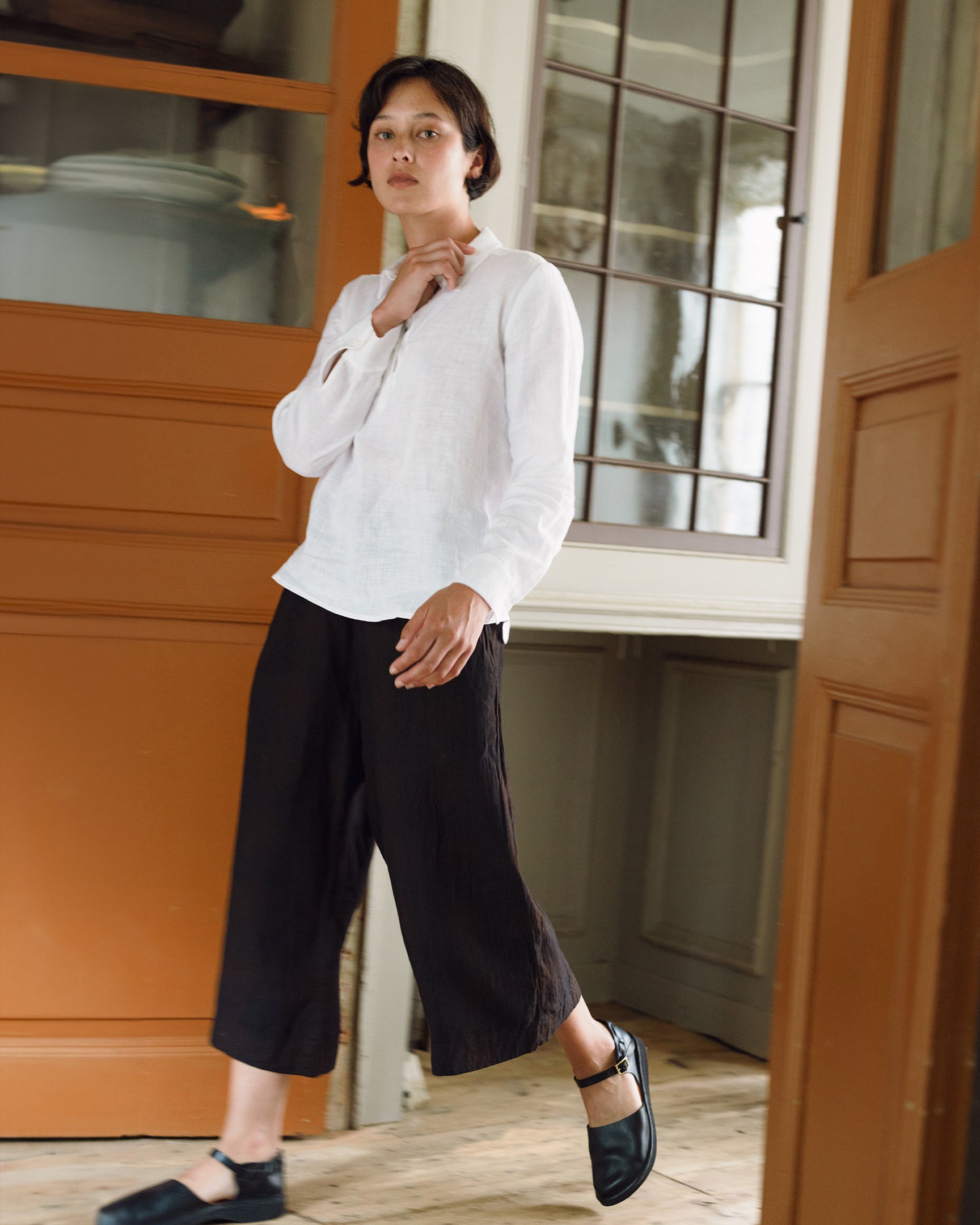Model walking in linen culottes in black