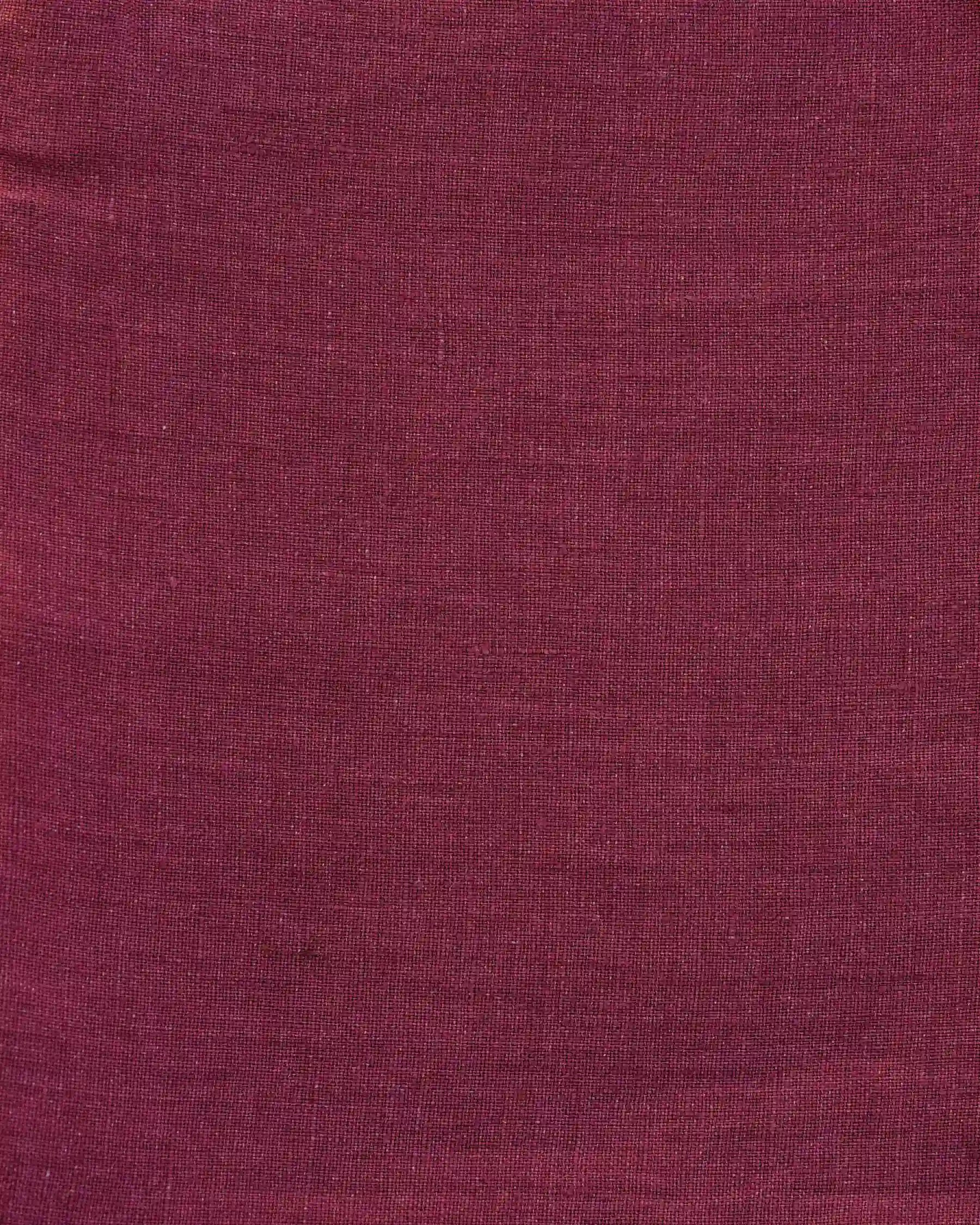 A close-up of the No.21 V Neck Sleeveless Linen Dress in Roan by Pyne and Smith Clothiers, made from maroon European flax linen with a subtle woven texture—perfect for a luxurious look.